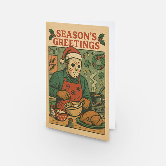 Funny horror Christmas card featuring Jason Voorhees in a Santa hat and apron, cooking a turkey with 'Season's Greetings' text and Christmas decorations.