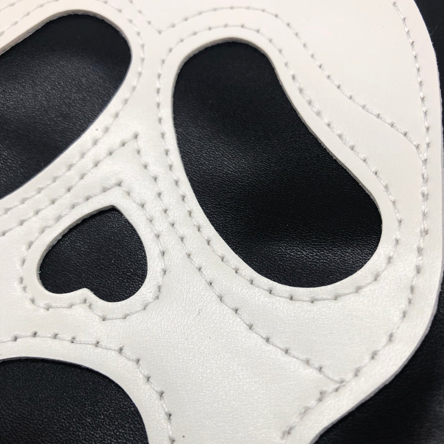 Close up picture of the faux leather Ghostface mask shoulder bag by Horrorfier to show the stitching detail 