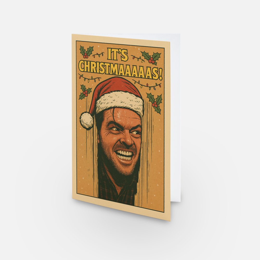 A Christmas card with Jack Nicholson  poking his head through the door from the infamous "Here's Johnny" scene from Stanley Kubrick's The Shining but this version has a humorous Christmas twist. The words say "It's Christmaaaas" in reference to the famous Christmas song intro by Slade.