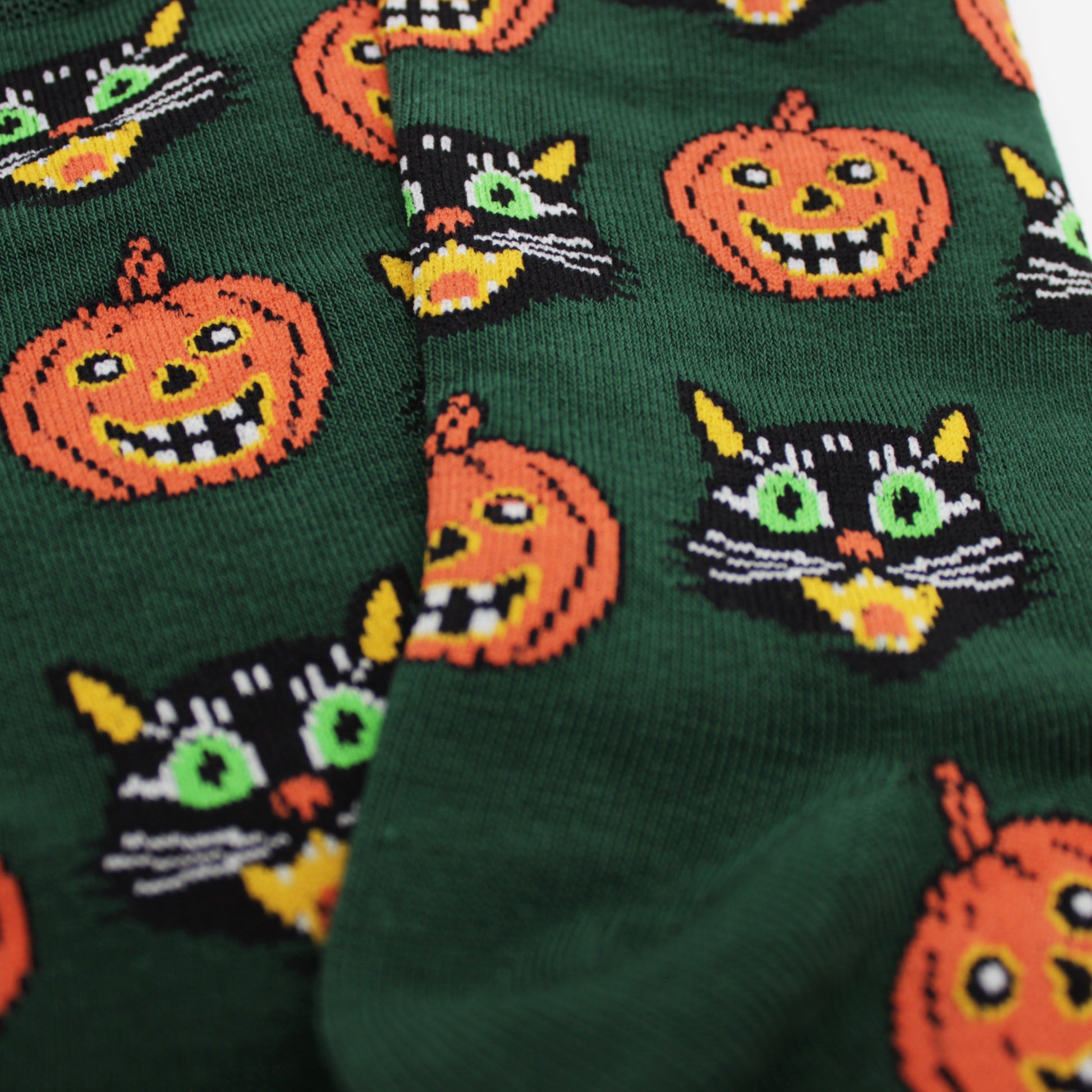 Close up of black cat and pumpkin Halloween socks